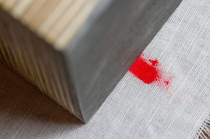 a piece of plywood on fabric with red color as example for a new abstract technology stock photo