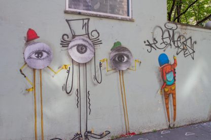graffiti collage, three eye-creatures with caps in red and green, one graffiti artist
