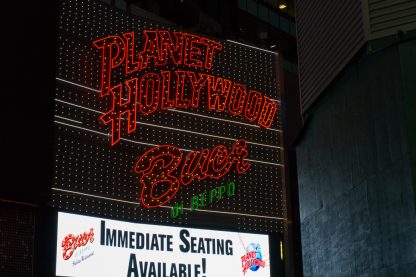 slightly curved lettering of the planet hollywood neon light